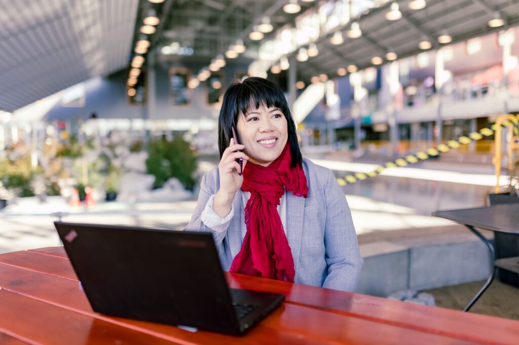 Michelle Chow making sales calls with laptop open